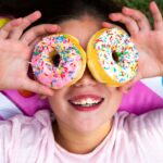 Too much sugar: Girl with donuts