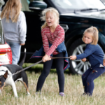 Savannah Phillips, Mia Tindall and Isla Phillips struggle to control their grandmother's (Princess Anne, Princess Royal) bull terrier dog 