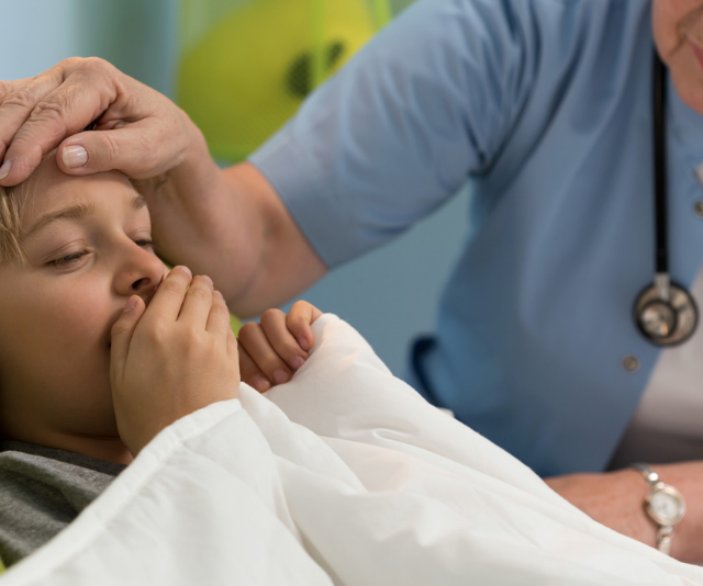 Small boy with pertussis whooping cough 