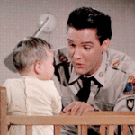 Elvis playing with a baby