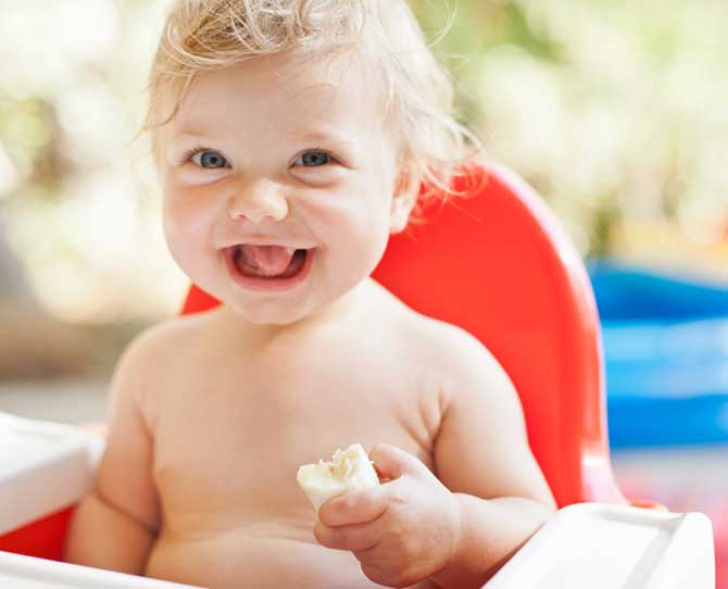 Baby eating banana