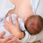 woman breastfeeding child