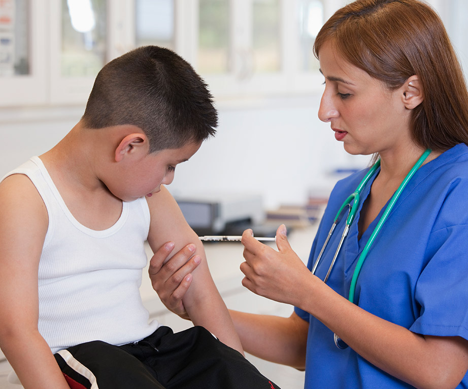 A young boy getting immunised.