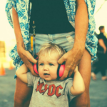 small child wearing headphones enjoying byron bay bluesfest