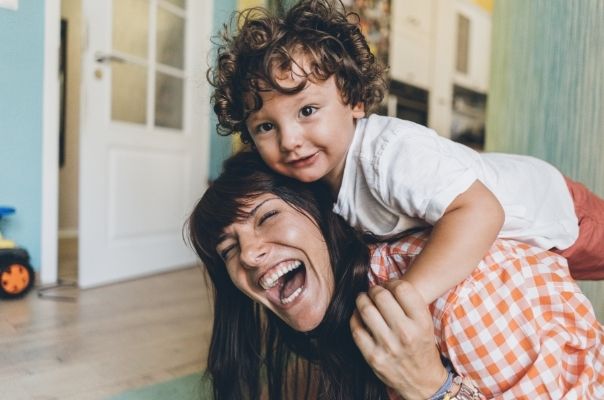 woman laughing with toddler