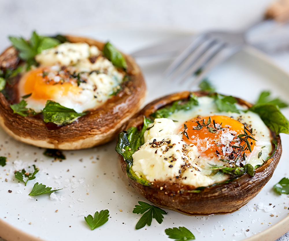 Baked breakfast flat mushrooms stuffed with spinach, feta and a gooey egg. 