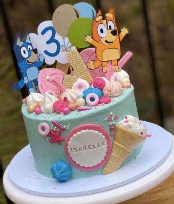 Colourful party cake with lots of Bluey character cake toppers
