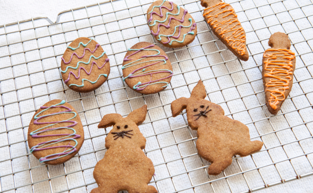 Wire tray with Easter egg decorated biscuits, carrot and rabbit shaped biscuits