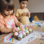Children decorataing Easter eggs together