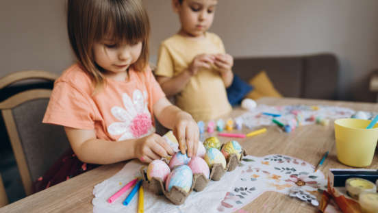Children decorataing Easter eggs together