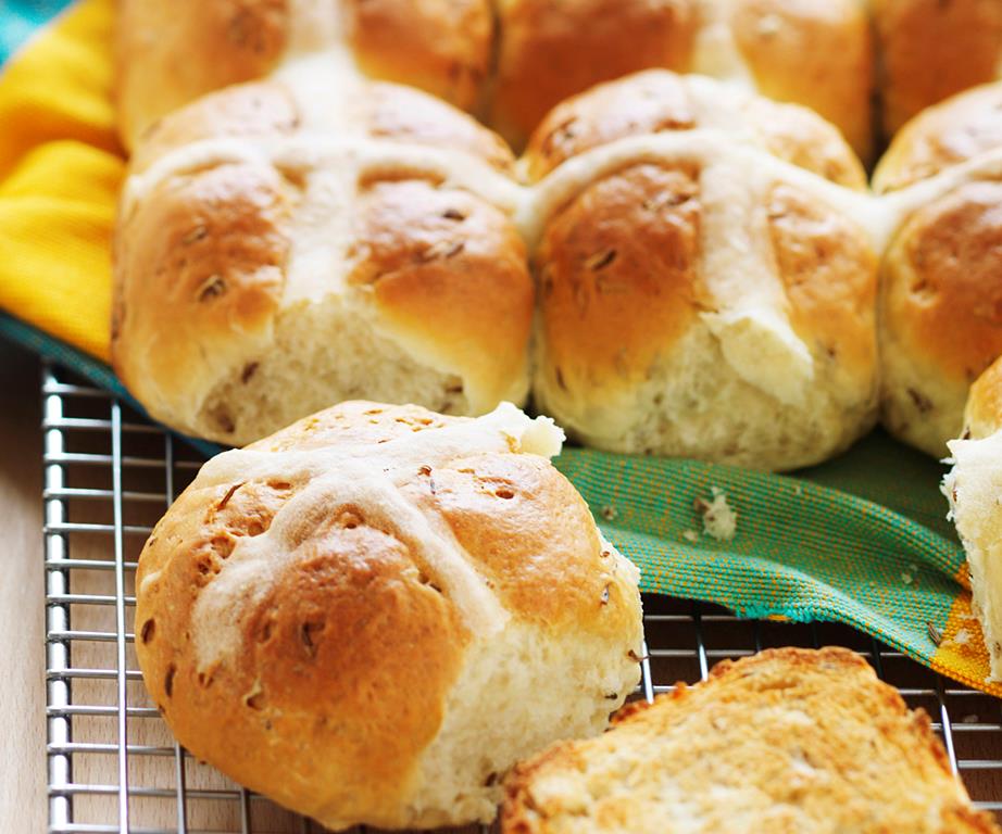 Close up image of savoury caraway seed hot cross buns