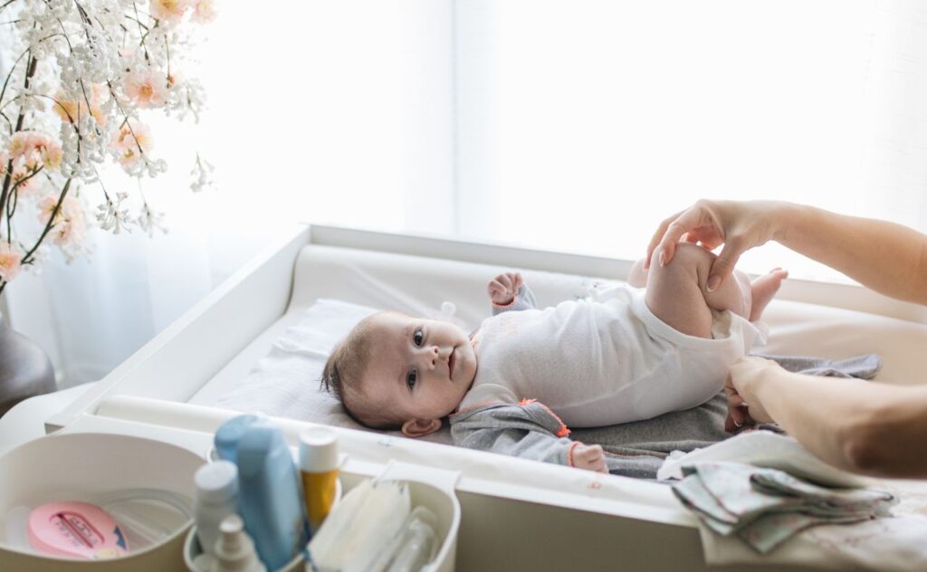 Baby having nappy changed at change table