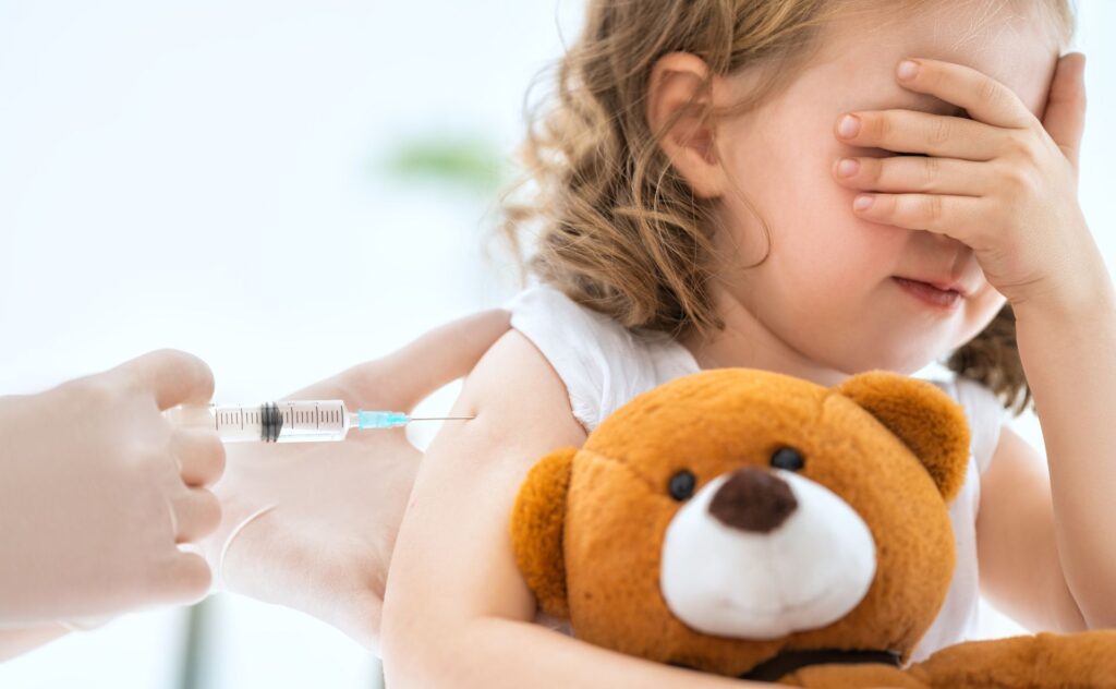 Flu vaccine: Young girl receiving flu shot