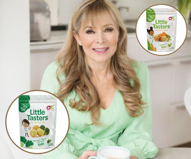 Annabel Karmel in a kitchen with images of Little Tasters snack foods for toddlers