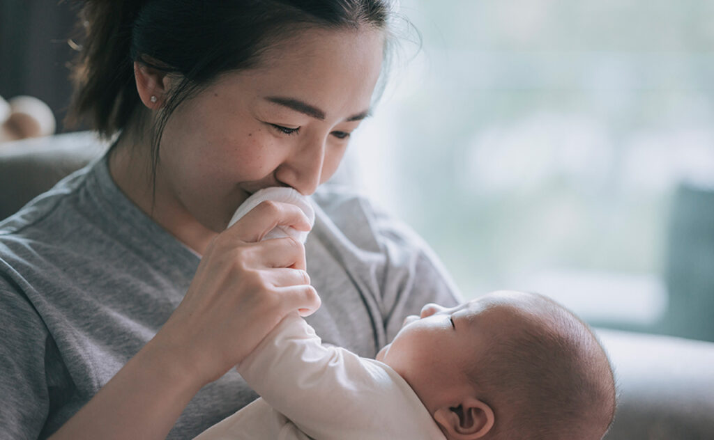 Asian Chinese Mother bonding time with her baby boy toddler at home
