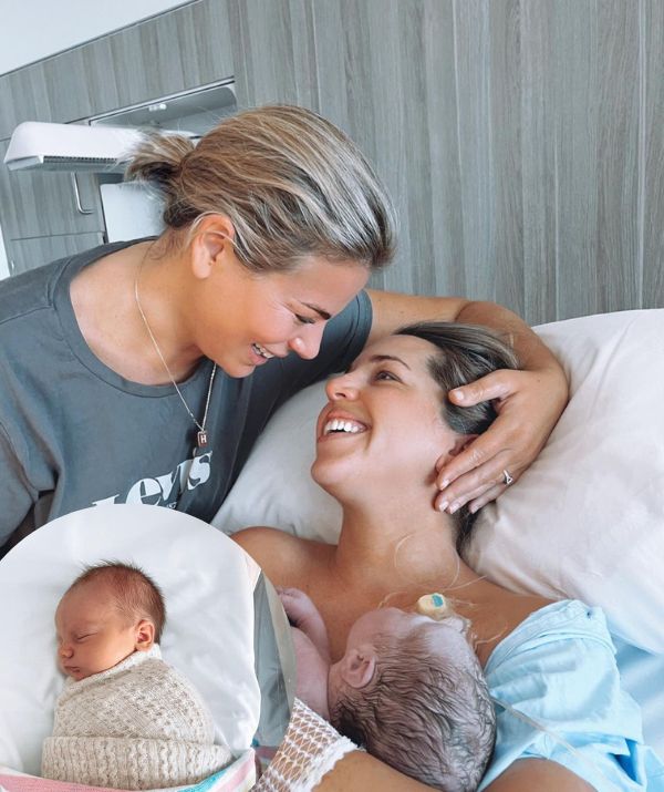 Fiona Falkiner smiles at partner Hayley Willis as she cradles newborn son Spencer