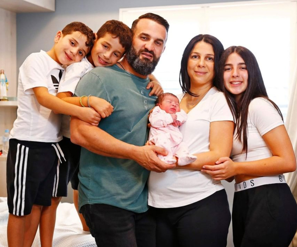 The Abdallah family together holding newborn baby Selina