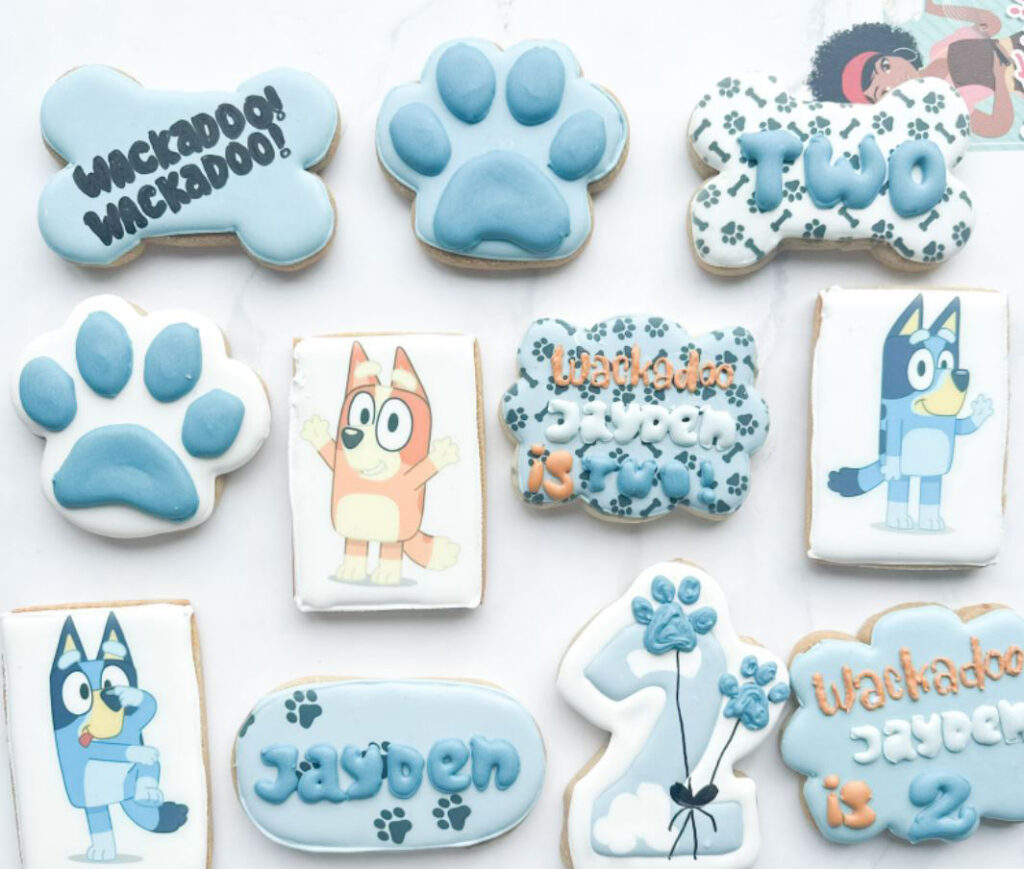 Selection of gorgeous Bluey themed cookies incluing characters, paw prints and more