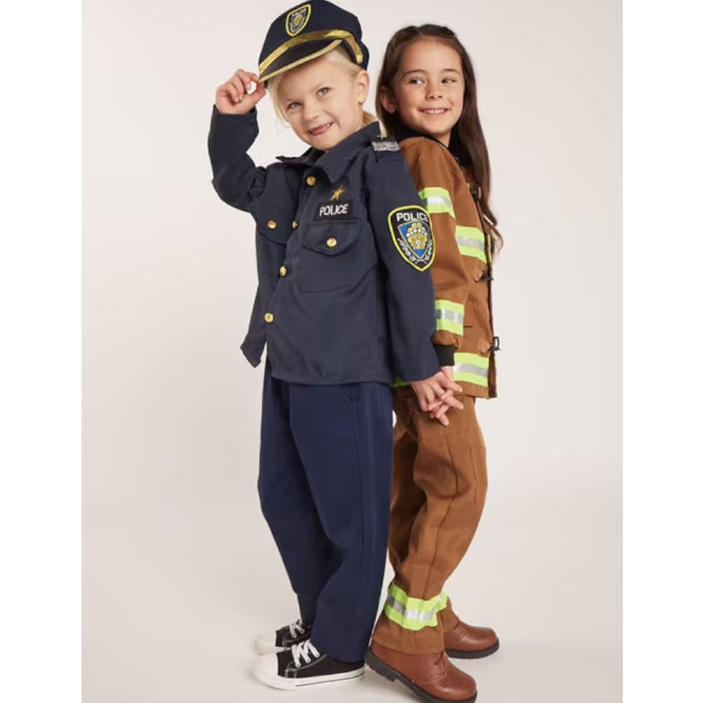 Two small girls wearing police and fireman fancy dress costumes.
