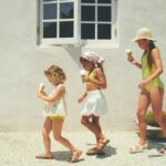 Billini Mini girls sandals: 3 girls wearing sandals walking in a line eating an ice-cream