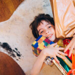 Young teenager boy holding Christmas presents.