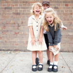 Three school kids wearing uniform and shoes