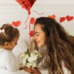Daughter giving mother flowers for Valentine's Day
