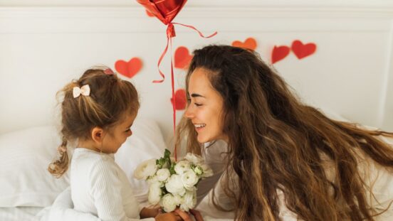 Daughter giving mother flowers for Valentine's Day