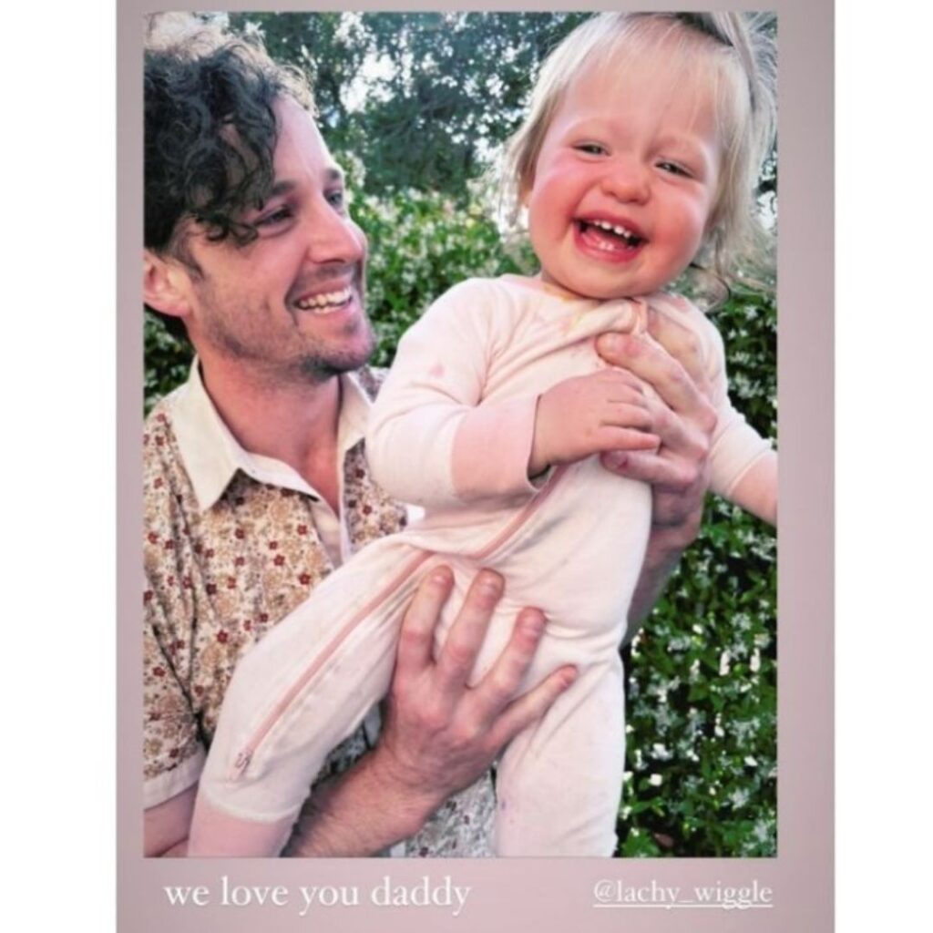 Lachy Wiggle Gillespie holding and smiling at his daughter