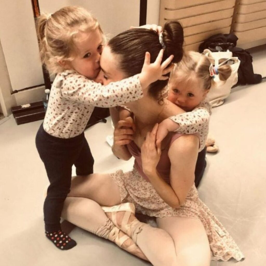 Lulu and Lottie cuddle their mother, Dana Stephensen while backstage at ballet