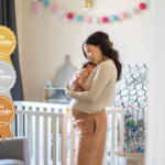 Best baby sleep aid or accessory. Mother with newborn in nursery