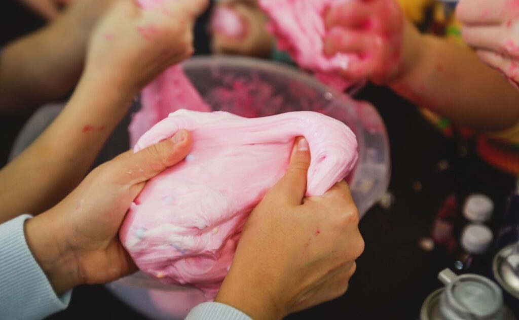 Girls making slime: Pink fluffy slime