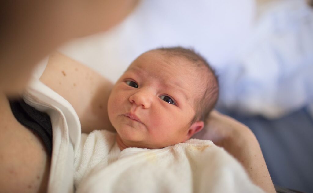 Mother holding newborn in hospital