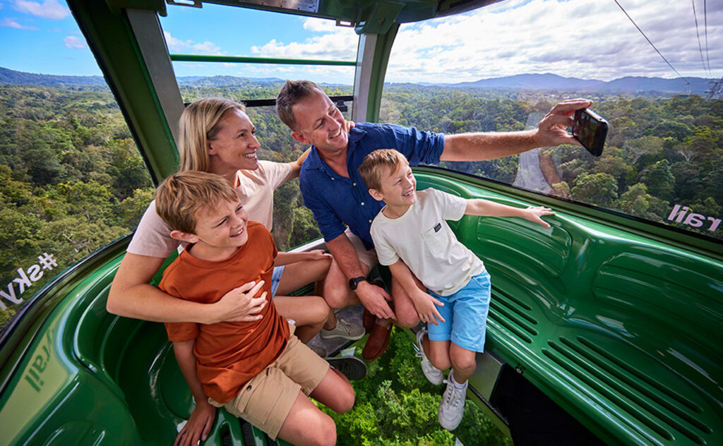 A family enjoy the scenery from the Skyrail Rainforest Cableway in Tropical North Queensland.