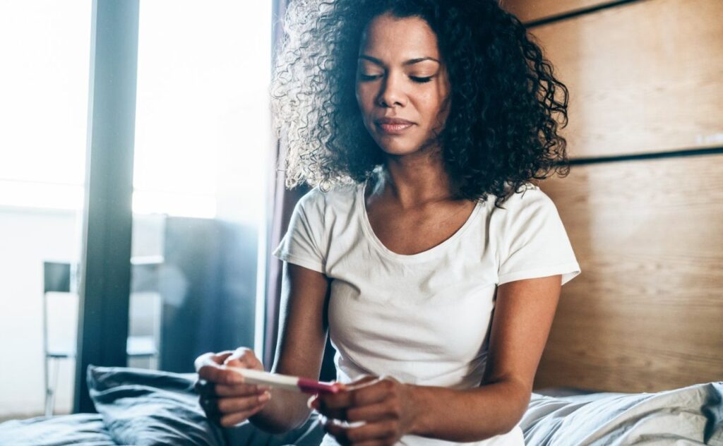 woman looking at pregnancy test