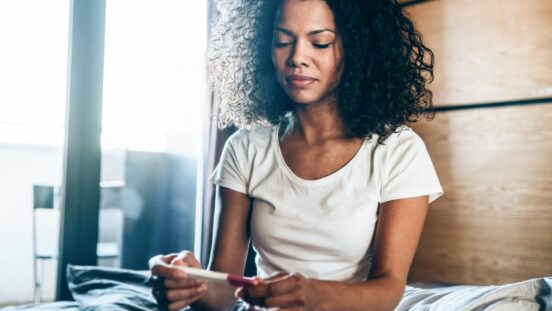 woman looking at pregnancy test