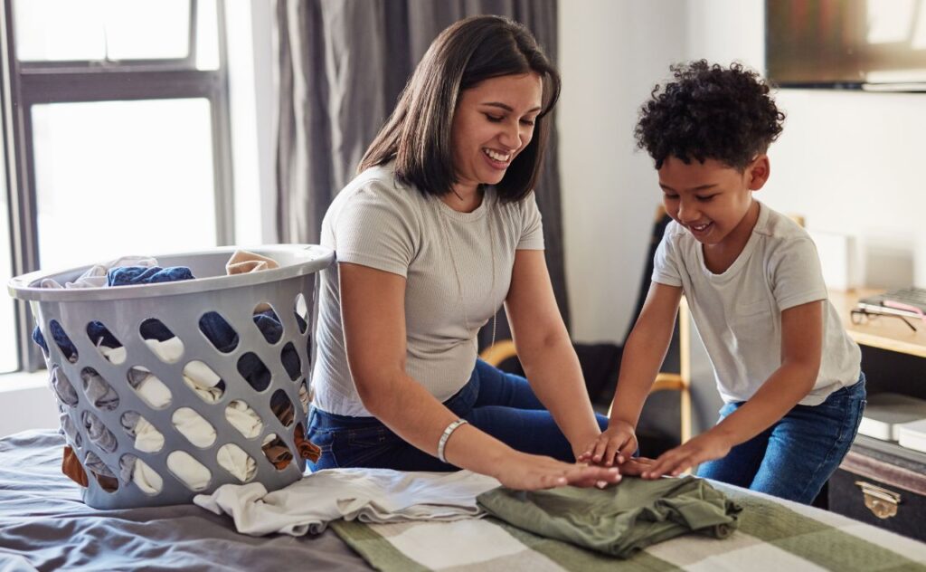 Mother and son folding laundry