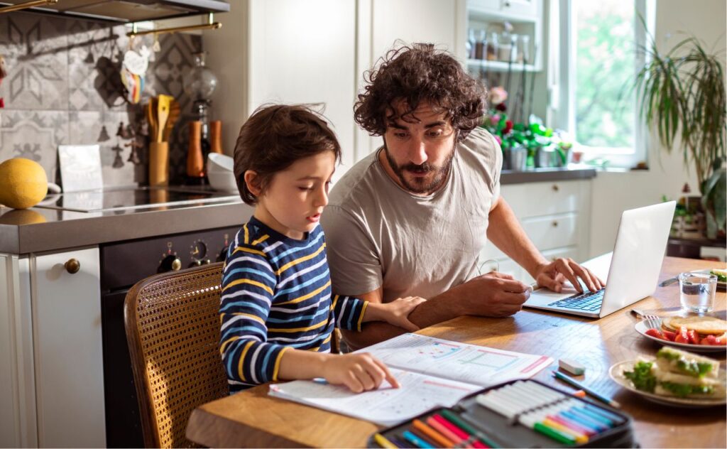 Parent helping son with homework