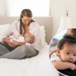 Mum with long fair hair sitting cross legged on a large bed breastfeeding baby; inset baby looking over dad's shoulder