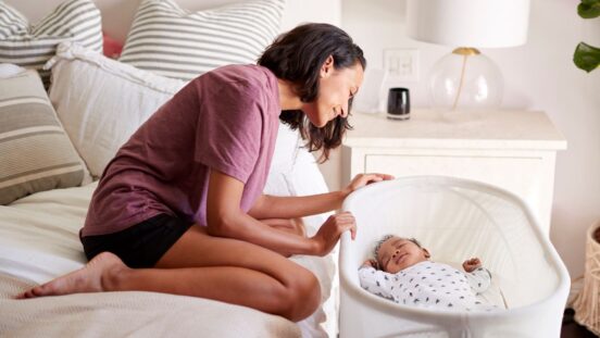 Mum watching baby sleep