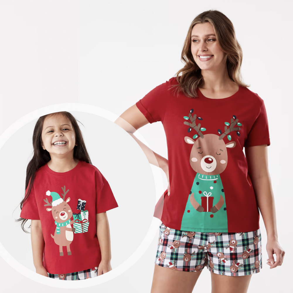 Woman with long hair wearing Christmas short PJs with a reindeer one and a young girl wearing a similar set