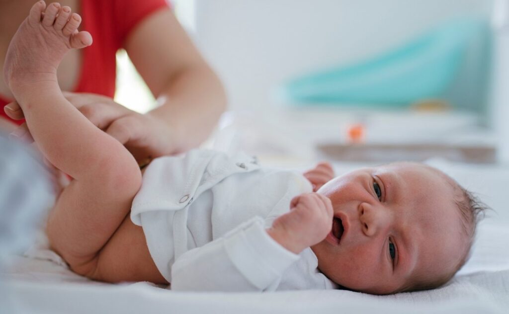 Newborn baby nappy change and their first meconium poo