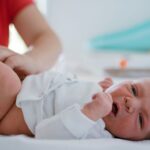 Newborn baby nappy change and their first meconium poo