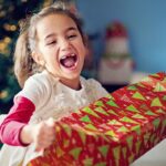 Young girl smiling with Christmas gift