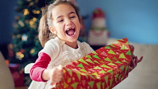 Young girl smiling with Christmas gift