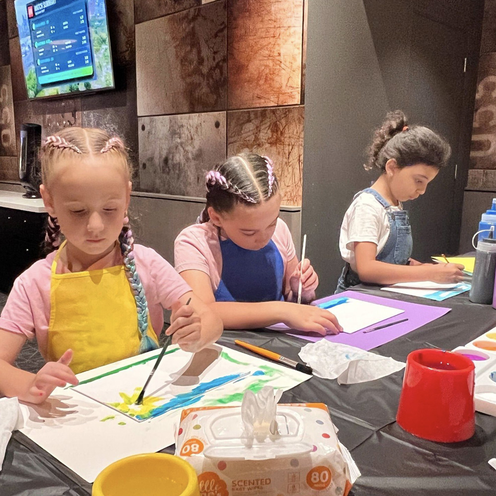 three young girls enjoy arts and crafts at the children's area of Campbelltown Catholic Club.