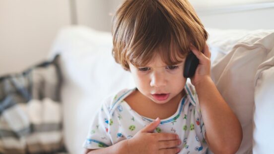 Young boy making a call on a mobile phone