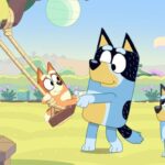 Extra long Bluey episode. Bandit pushing Bingo on a swing while Bluey watches.