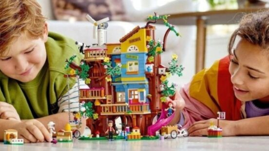 Two kids playing with LEGO Friends Friendship Tree House 41703