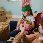 Family including young girl with a Christmas cracker